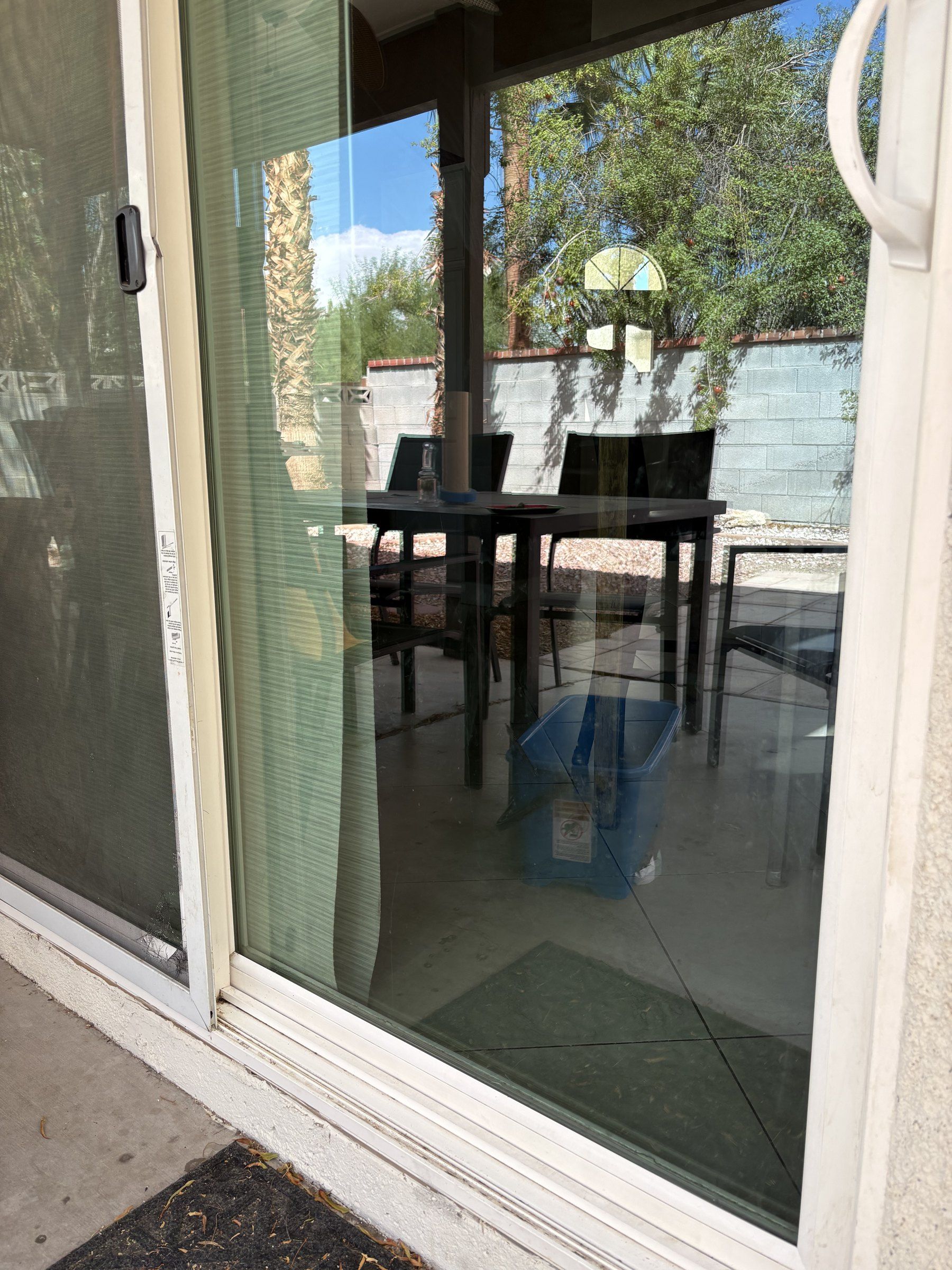 Cleaned sliding glass door and screen at a Las Vegas Valley home, with the shaded patio behind it
